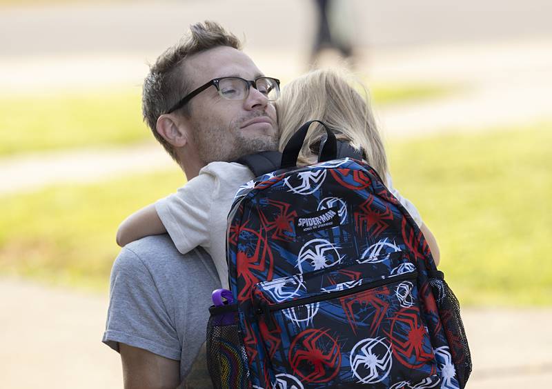 Jacob Reitzel hugs his first grade son Vann Wednesday, Aug. 14, 2024 as the youngster heads into Washington school in Dixon.