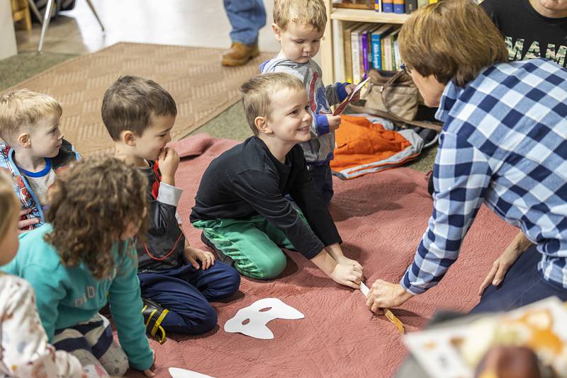 Augusten Anderson, 5, of Dixon pounces on a mouse much like a fox might while looking for a tasty snack. Nancy Wadsworth has been leading the nature program for the last three years.