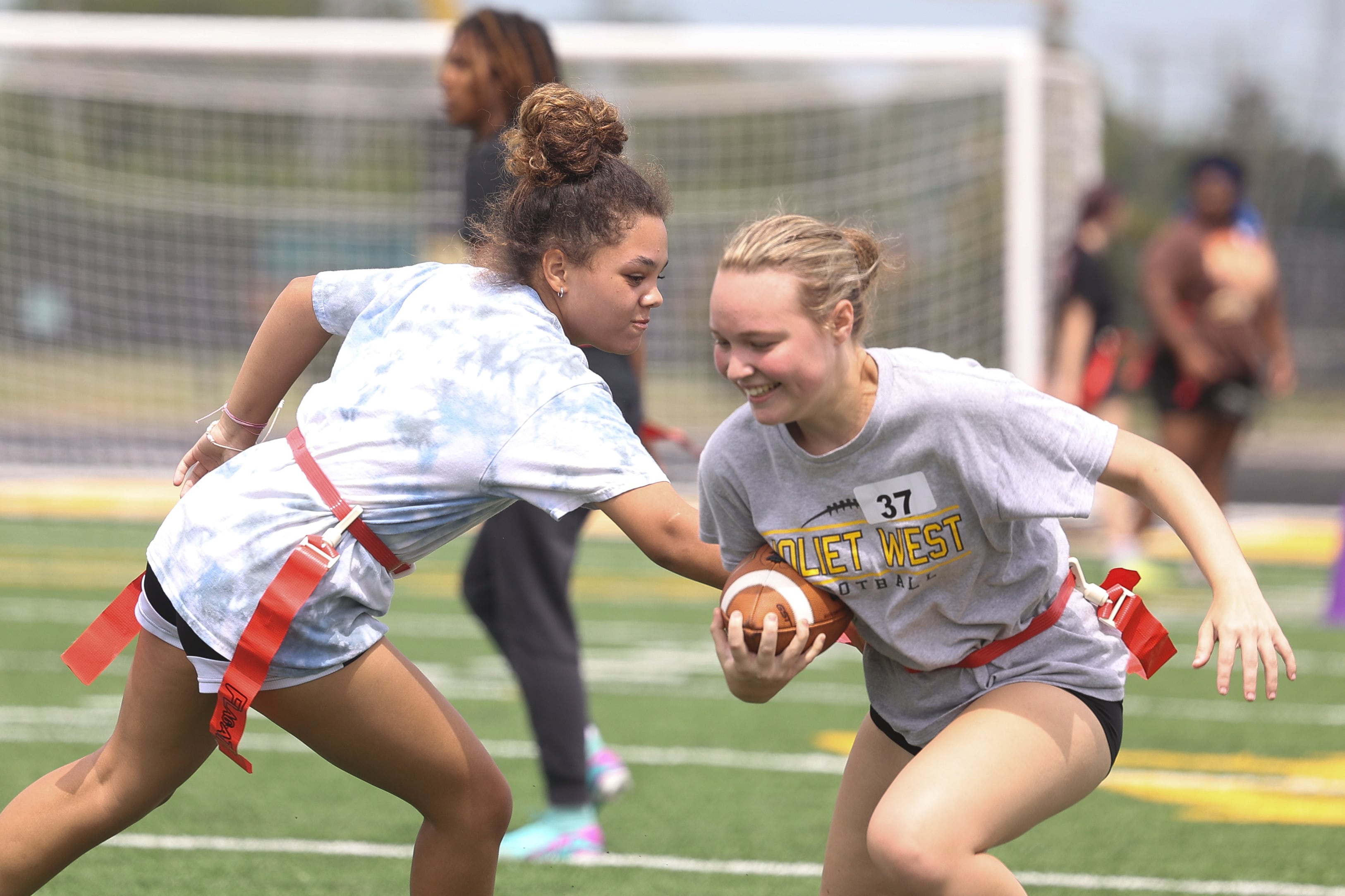 Xierra Rapata, right, tries to evade Karson Davis-Mast during Joliet West’s girls flag football tryouts on Monday, Aug. 12, 2024  at Joliet West High School.