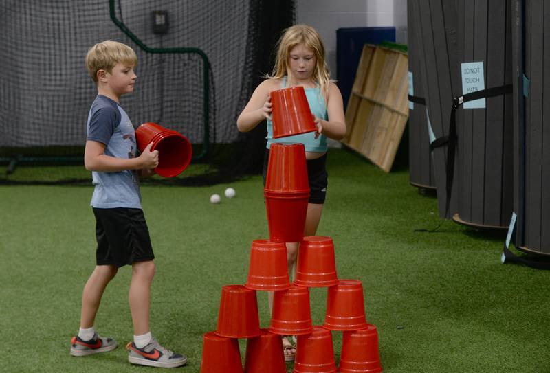 (left) Owen Melton and Addie Ingrum of Glen Ellyn play a variety of games and activities together during the Glen Ellyn Park District unplug from technology event held Saturday July 13, 2024.