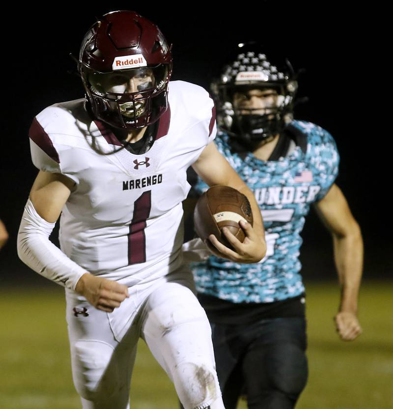 Marengo's David Lopez runs for his second touchdown as he is chased by Woodstock North's Michael Pintor during a Kishwaukee River Conference football game on Friday, Sept. 13, 2024, at Woodstock North High School.