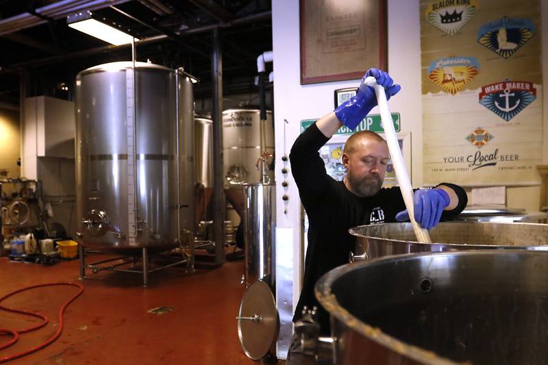 Cellerman Pete Mangan stirs a batch of Hefe Weizen beer on Friday, May 3, 2024 at the Crystal Lake Brewing. The brewery is celebrating its 10th anniversary and recently won a bronze award in Brown Porter category at the World Beer Cup in Las Vegas.