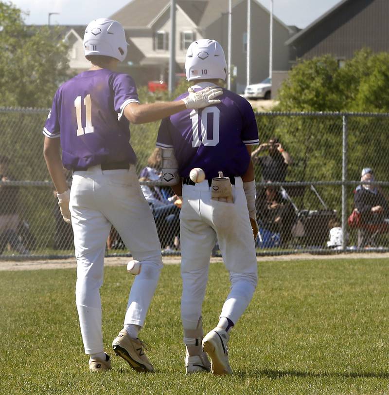 Hampshire's Charles Wiggins comforts his teammate, Hampshire's Dominic Borecky after McHenry defeated Hampshire 5-4 in a Class 4A Hampshire sectional baseball game on Wednesday, May 29, 2024, at the Hampshire High School.