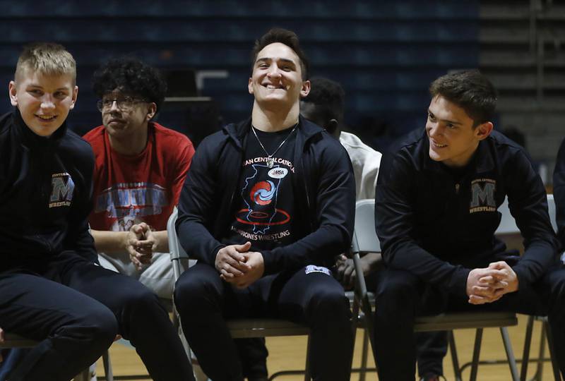 Wrestlers Jimmy Mastny, Max Astacio and  Nic Astacio laugh as Marina Central honors their wrestlers that brought home the IHSA Class 1A Dual Team State Championship title on Friday, March 8, 2024, during a celebration at the high school in Woodstock.