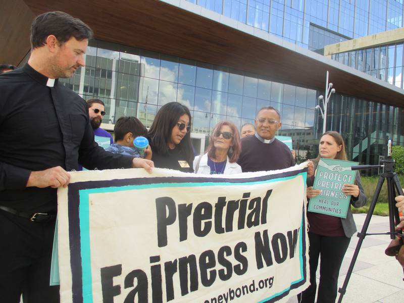 Will County Board Member Destinee Ortiz, center, speaks Monday at a press conference staged outside the Will County Courthouse in Joliet by advocates celebrating the implementation of cashless bail in Illinois. Sep;t. 19, 2023.