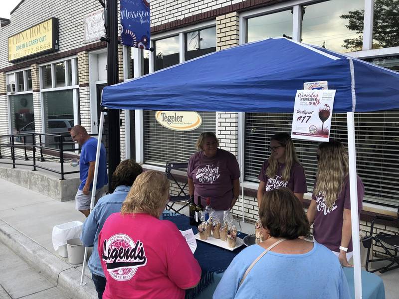 Guests stop at the Tegeler Accounting booth during the Winesday Wednesday Walk on Aug. 9, 2023, in Morrison.