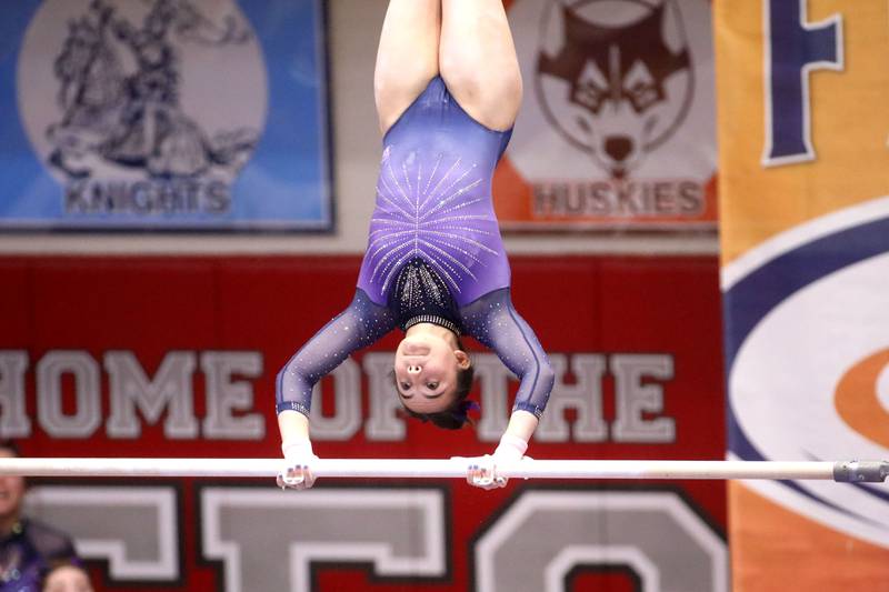 Downers Grove South’s Genevieve Herion competes on the uneven parallel bars during the IHSA Girls State Gymnastics Meet at Palatine High School on Friday, Feb. 16, 2024.