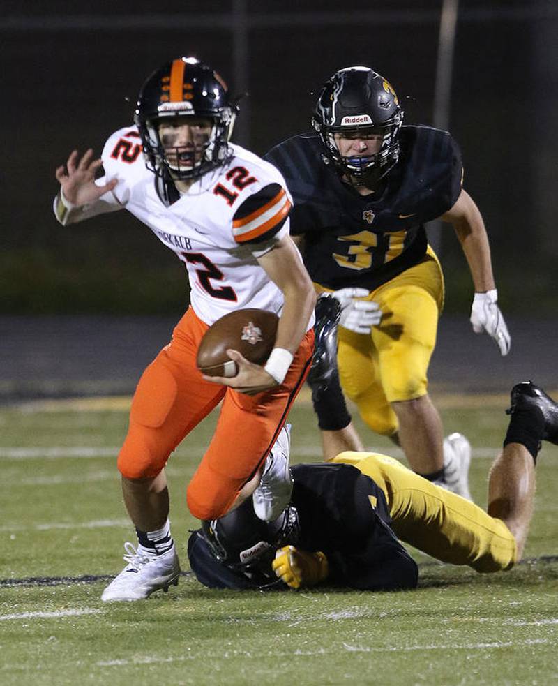 DeKalb quarterback Trenton Kyler escapes a tackler during a game this season against Metea Valley High School in Aurora.