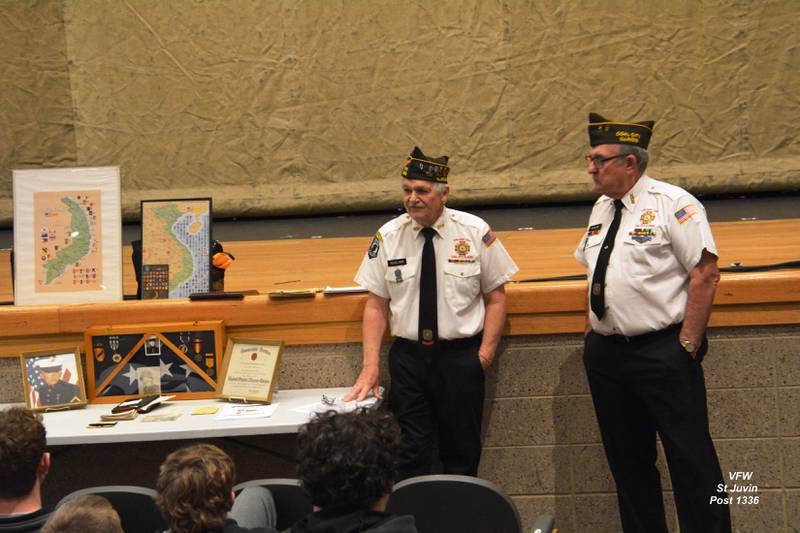 Adjutant and Quartermaster Keith Roseland explains the significance of Lance Corporal Cecil Lee Russell's memorabilia along with Earl "Shorty" Fatlan (right).