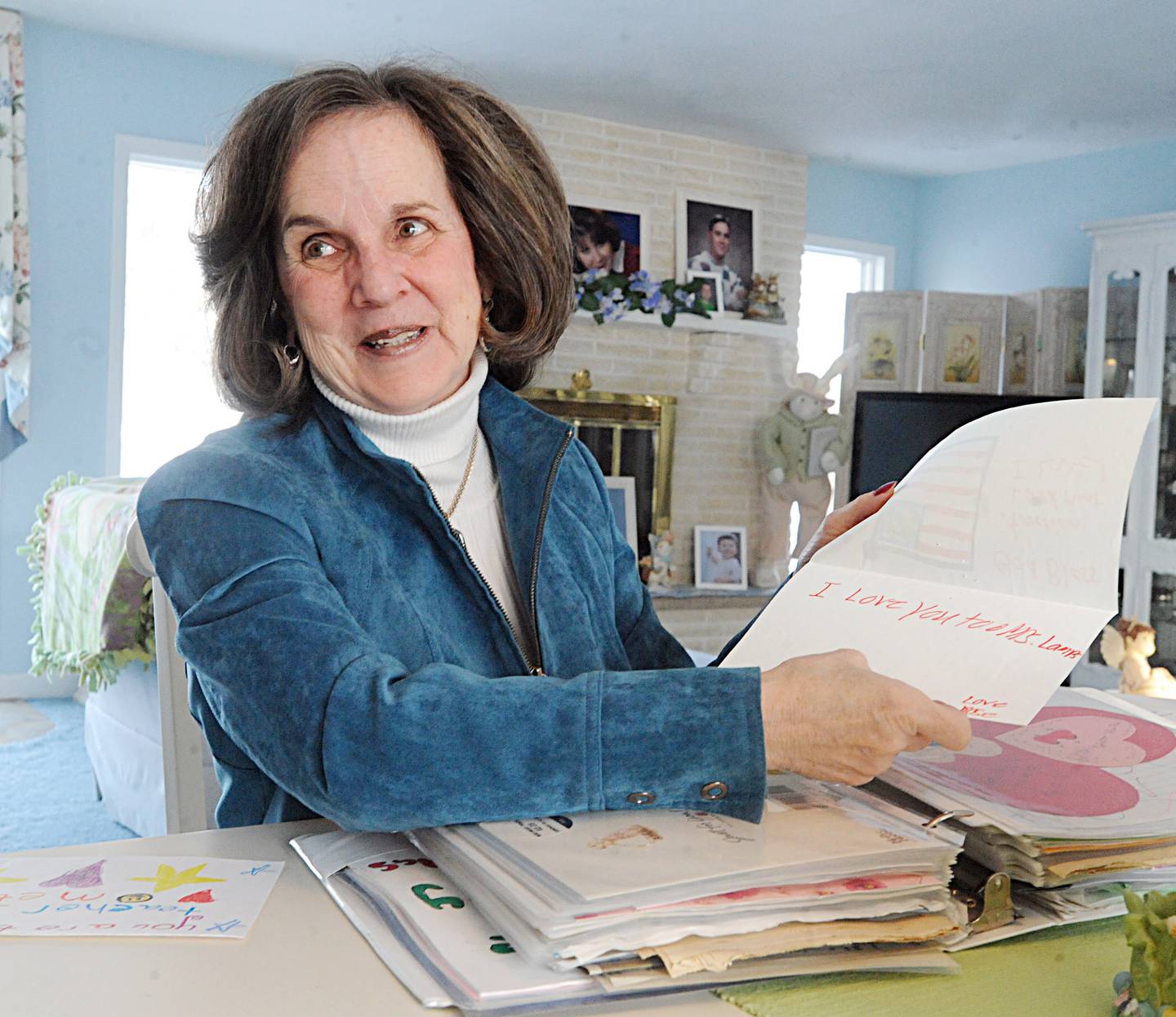 Sharon Lamps, teacher at Dalzell Grade School, flips through a scrap book of letters and drawings that she received from children throughout her 35 years of teaching at her home in 2016 in Dimmick. Lamps currently teaches part time at the school on Tuesdays and Thursdays.