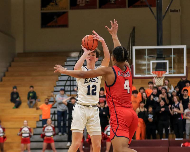 Oswego East's Ryan Johnson (12) shoots a jump shot during Class 4A Lockport Regional final game between West Aurora at Oswego East.  Feb 24, 2023.