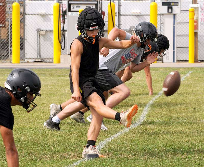 Sandwich football player Nate Hill kicks off during a drill on the first day of football practice at Sandwich High School on Monday, Aug. 12, 2024.