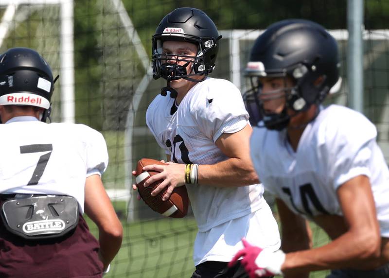 Sycamore quarterback Burke Gautcher looks for a receiver Monday, July 15, 2024, during summer football camp at Sycamore High School.