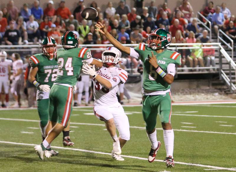 L-P quarterback Marion Persich throws a pass to Michael Hartman to score a touchdown against Ottawa on Friday, Sept. 13, 2024 at Howard Fellows Stadium.