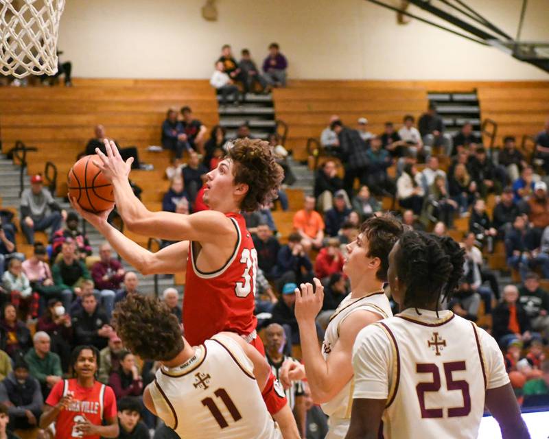 Yorkville's Bryce Salek (30) goes up for a shot and gets call for a charging foul on St. Ignatius's Philip Erickson (11) in the first quarter on Tuesday Dec. 26, 2023, at the Jack Tosh tournament held at York High School in Elmhurst.