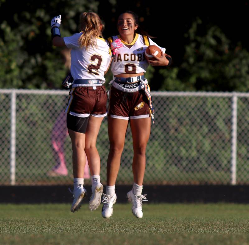 Jacobs’ Brie Verburg, right, celebrates a long run with teammate Dusia Panek in varsity flag football on Tuesday, Sept. 3, 2024, at Dundee-Crown High School in Carpentersville.