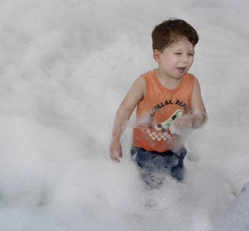Jackson Roberts runs through a field of foam doing the Starved Rock Regional Centers Kids Expo Saturday in Ottawa.