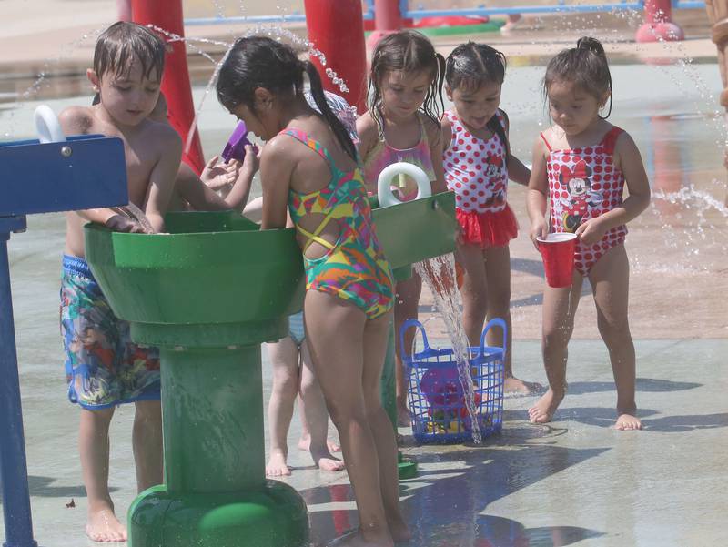 Children play with water in the Splash Field at Washington Park on Monday, June 17, 2024 in Peru.