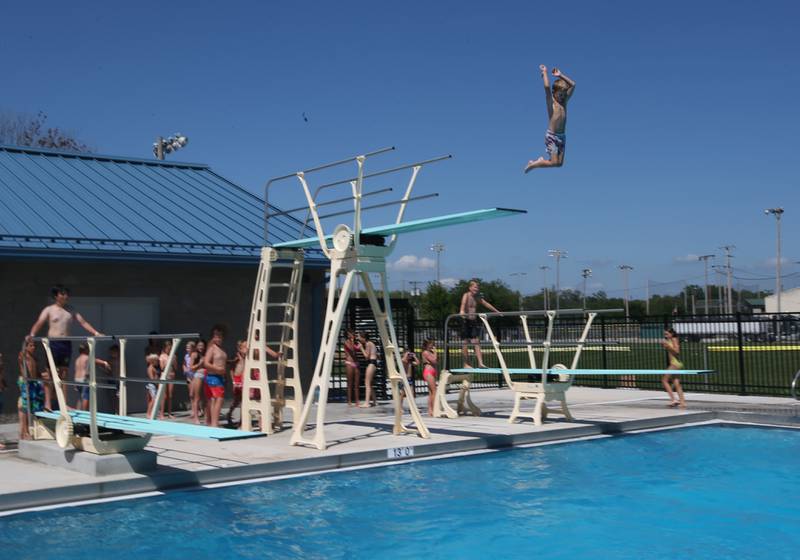Gus Manning of Ottawa (top) dives off of the high-dive on Thursday, July 27, 2023 at Riordan Pool in Ottawa.