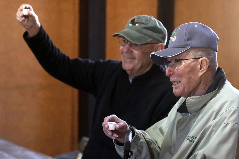 Dale Hatter of Huntley and Richard Kilian, of Roselle, toast with maple syrup during a maple syrup tasting during the McHenry County Conservation District’s annual Festival of the Sugar Maples, at Coral Woods Conservation Area, in Marengo, on Monday, March 11, 2024.