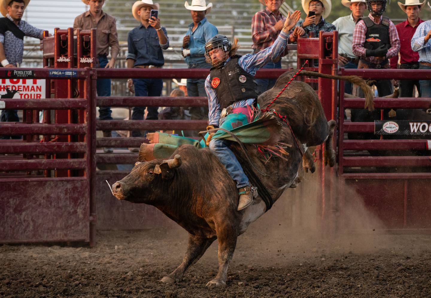 Ty Davison rides a bull during the Tuff Hedeman Tour during the 75th anniversary of the McHenry County Fair in Woodstock on Friday, August 4, 2023.