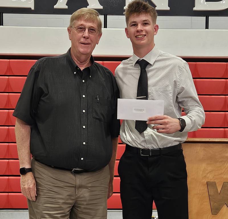 Chuck Hayward presents the Coach Jerry Ross and the Elite 8 Scholarship to Jonathan Moore.