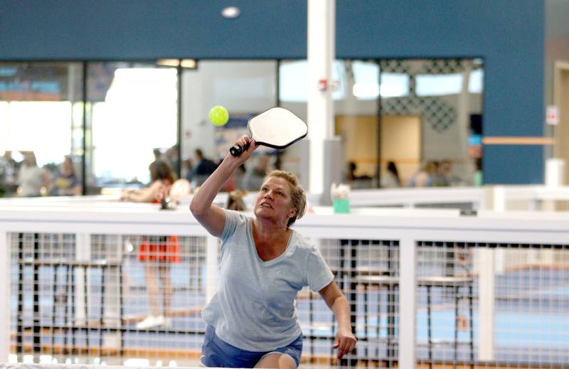 Kyra Moravec of Crystal Lake plays Pickle Ball with Steve Otten of Crystal Lake during a patio launch party at Pickle Haus in Algonquin Friday night.