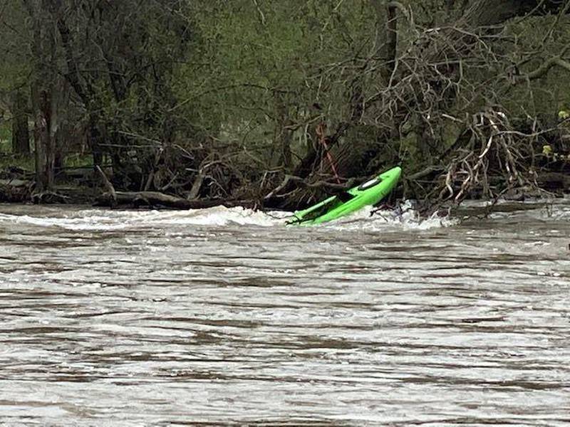 A kayak remains in the Des Plaines river in Riverside after it capsized Saturday causing fire personnel to rescue the kayaker. Photo provided.