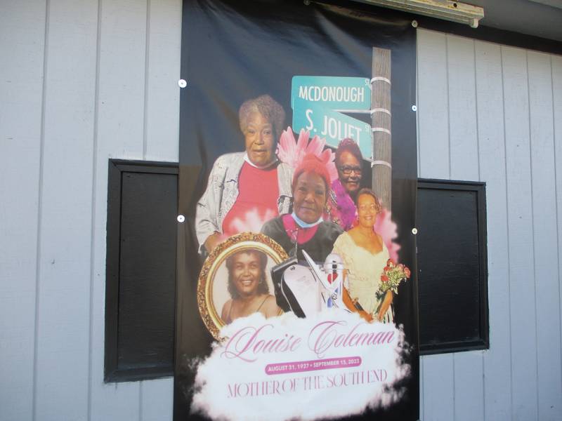 A poster containing multiple photos of Louise Coleman decorates the outside wall of Seward's Barbershop, which she managed for several decades. She is described here as "Mother of the South End," recognizing Coleman's influence in the Joliet neighborhood. Feb. 25, 2024.