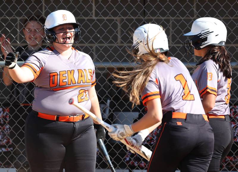 DeKalb players celebrate after a run scores during their Class 4A regional semifinal game against Rockford Auburn Wednesday, May 22, 2024, at Hampshire High School.