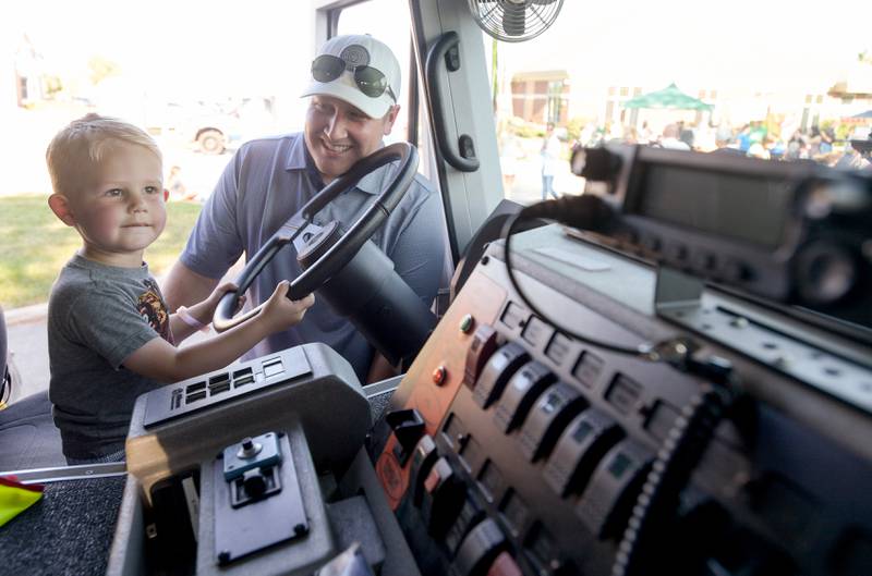 Aiden Velleman, 3 and his dad Paul check out the inside of a fire truck during the Campton Hills National Night Out event on Tuesday, August 2, 2022.