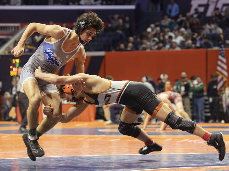 Princeton’s Ace Christiansen avoids Sandwich’s Cooper Corder in the 138 pound 1A third place match Saturday, Feb. 17, 2024 at the IHSA state wrestling finals at the State Farm Center in Champaign.