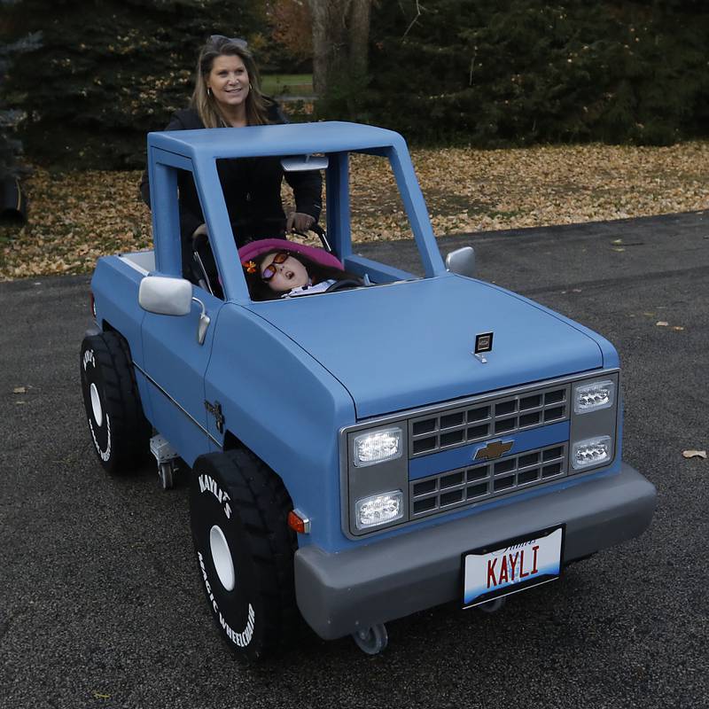 Kelly Whistler pushes her daughter, Kayli, 14, who is living with Trisomy 18, in her custom pickup truck costume that goes over her wheelchair on Tuesday, Oct. 31, 2023. The costume was made by Stryker Sage.