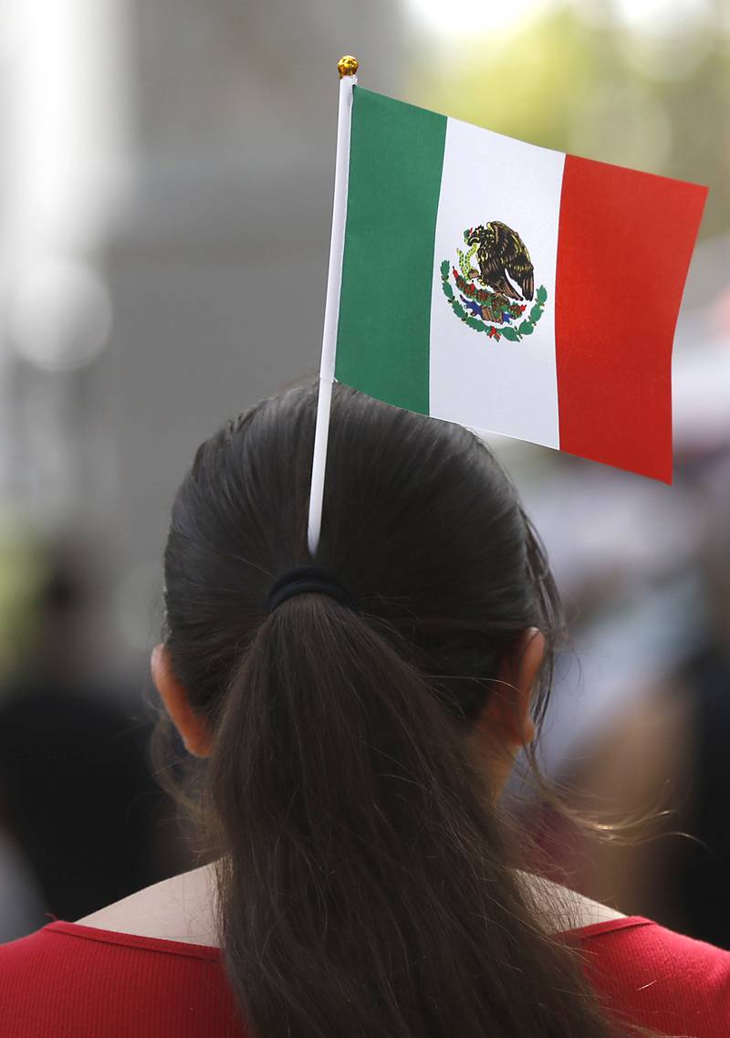 A girls wears a Mexican flag in her hair during the annual Hispanic Connections Mexican Independence Day Celebration on Sunday, Sept. 15, 2024, in the Historic Woodstock Square. The celebration featured music, food and culture.