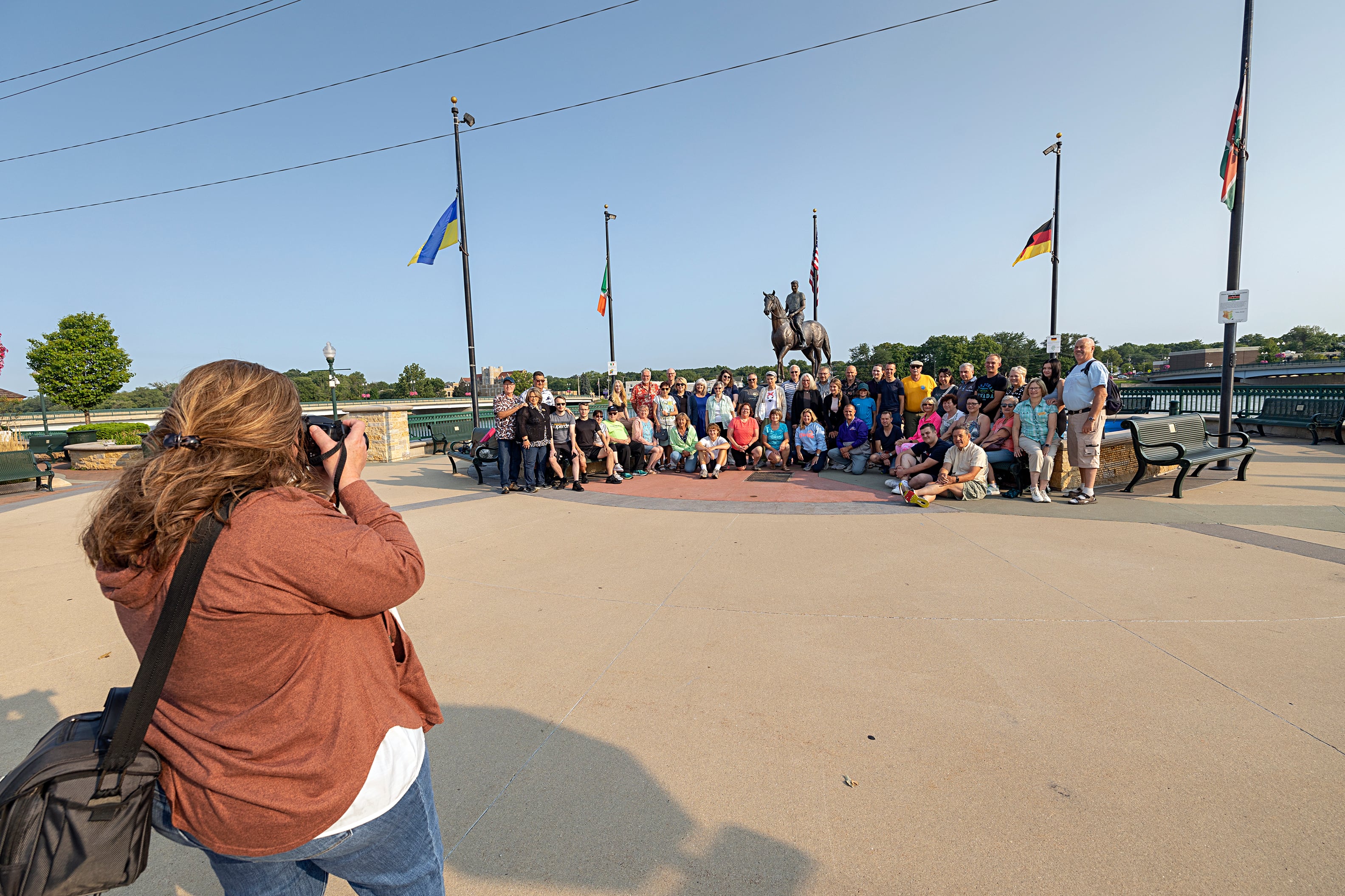 Trisha Harden Hirte takes a picture of the German delegates and their Sister City host families Friday, July 26, 2024, on the Dixon riverfront. The group then planned to tour the John Deere Historic Site.