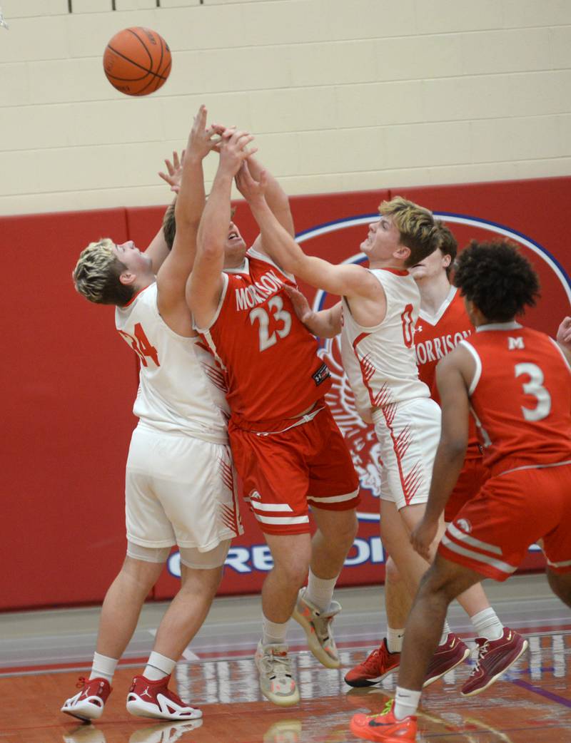 Morrison's Carson Strating (23) battles Oregon's Kade Girton (34) and Cooper Johnson (0) during 2A regional action on Monday, Feb. 19, 2024 at the Blackhawk Center in Oregon. The Mustangs downed the Hawks 59-52 to advance to the Prophetstown Regional on Wednesday, Feb. 21.