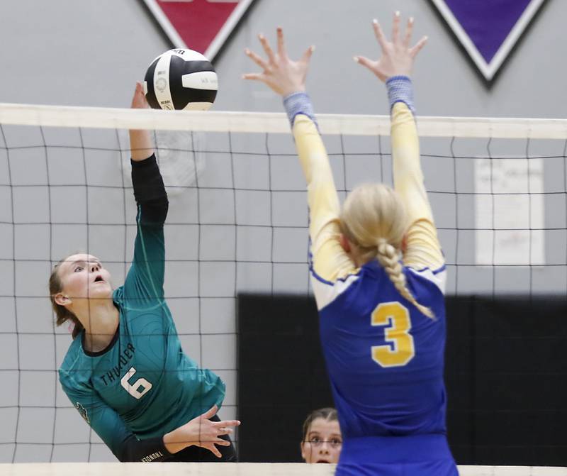 Woodstock North's Tayler Menzel hits the ball past the block attempt of Johnsburg's Alexis Sweetwood during a Kishwaukee River Conference volleyball match on Wednesday, Sept. 4, 2024, at Woodstock North High School.