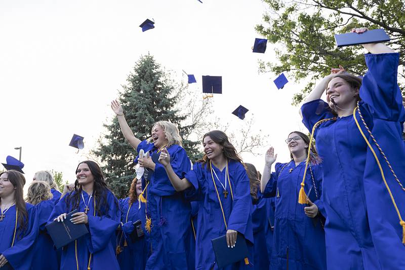 Newman Central Catholic High School grads fire their hats into the air after commencement Wednesday, May 15, 2024.