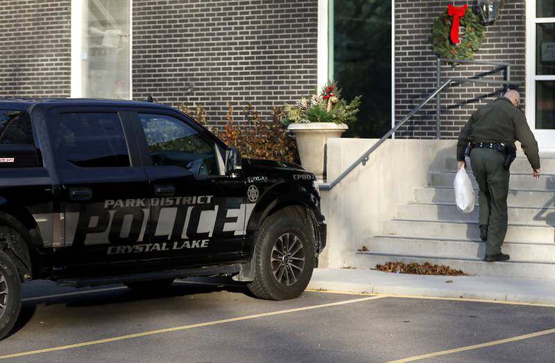 A Crystal Lake Park District police officer walks into the Crystal Lake Park District office on Wednesday, Dec. 20, 2023, in Crystal Lake. The park board is considering disbanding its police department that was established in 1924 and is the only park district police force in McHenry County.