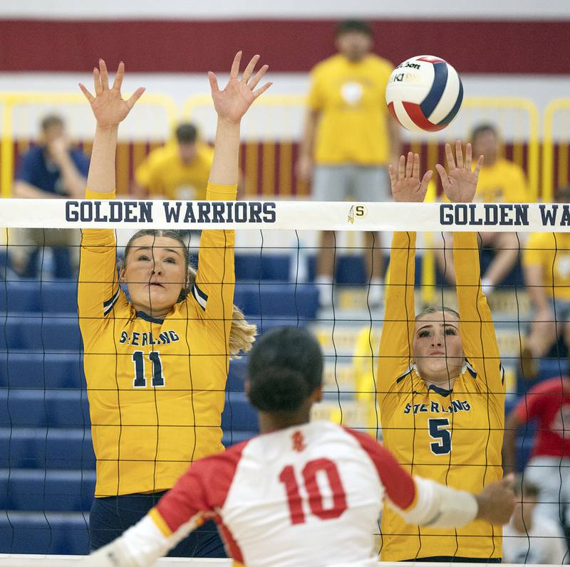 Sterling’s Natalie Eddinger (left) and Payton Ottens goes up for a block against Rock Island Tuesday, Sept. 17, 2024.