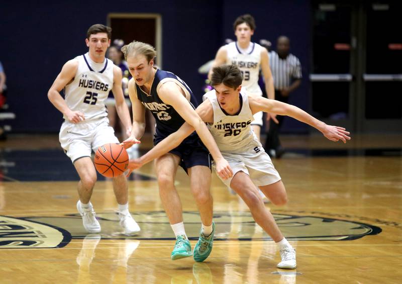 Harvest Christian Academy’s Kaden Meeker (left) and Serena’s Beau Raikes go after a loose ball during the Class 1A Harvest Christian Academy Sectional semifinal game on Wednesday, Feb. 28, 2024 in Elgin.