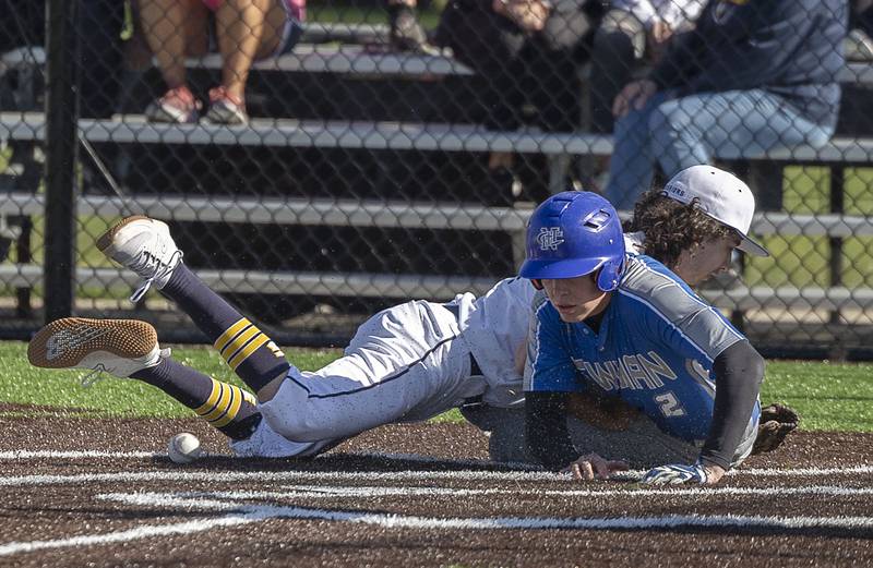 Newman’s Daniel Kelly successfully steals home on a wild pitch as Sterling’s Gio Cantu is unable to make the catch while covering the plate Wednesday, May 3, 2023.