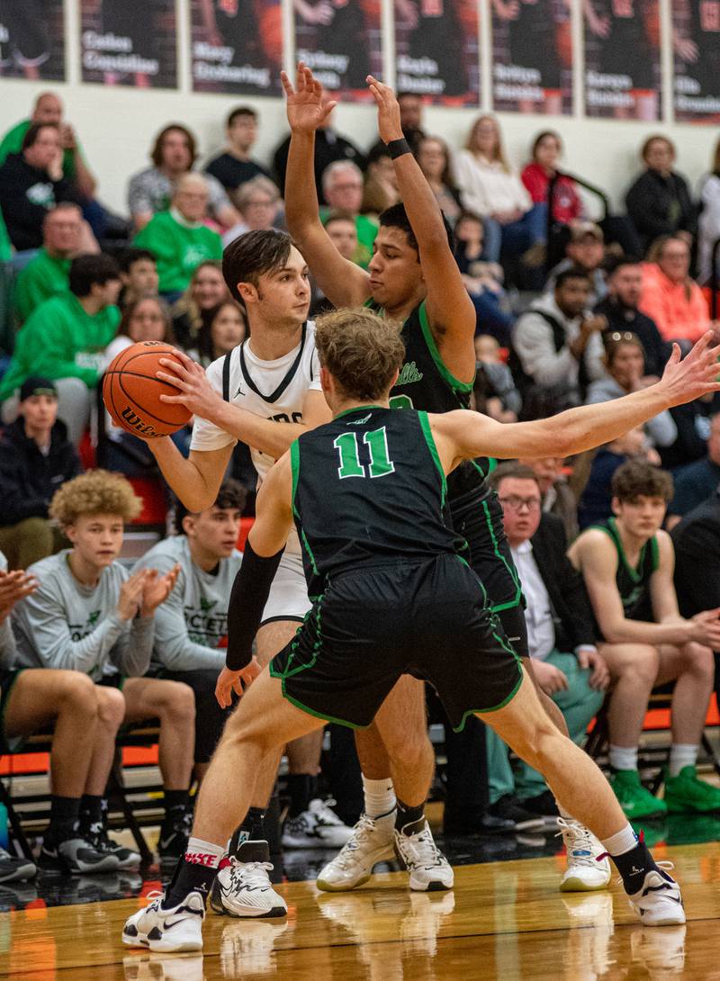 Rock Falls' Gavin Sands (11) and Diego Hernandez double-team Byron's Nick Kesler during the first quarter of the Class 2A Byron Regional championship game on Saturday, Feb. 25, 2023. The Rockets topped the Tigers 43-40.