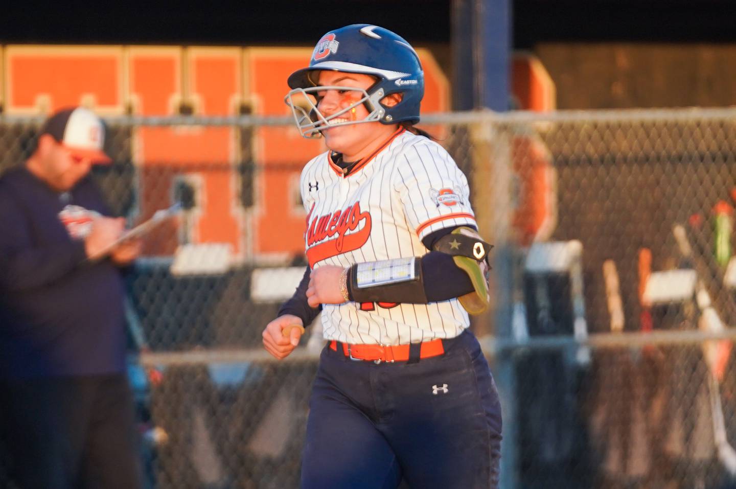 Oswego’s Kiyah Chavez (10) smiles after rounding third base after hitting a home run against Downers Grove South during a softball game at Oswego High School on Tuesday, March 19, 2024.