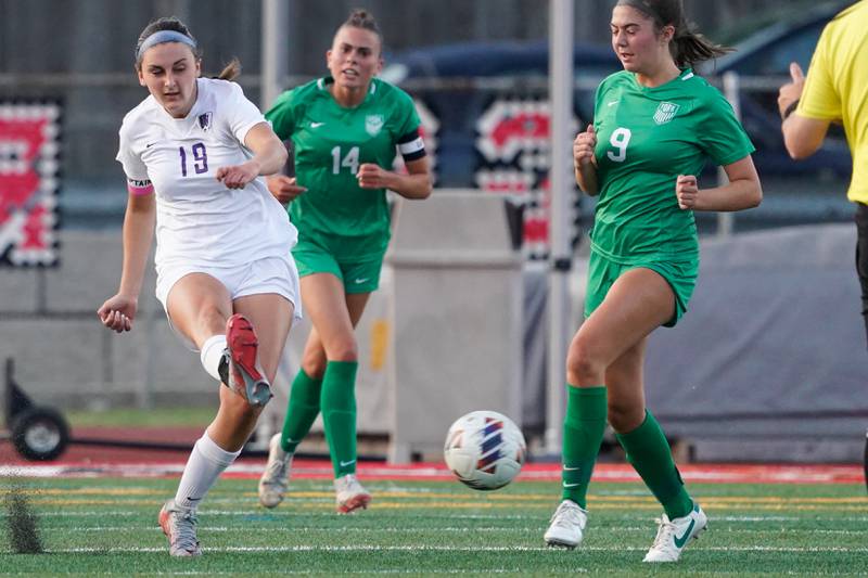 Downers Grove North's Addison Liszka (19) shoots the ball against York during a Class 3A Hinsdale Central Sectional semifinal soccer match at Hinsdale Central High School in Hinsdale on Tuesday, May 21, 2024.