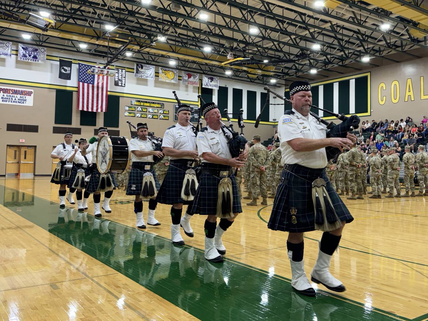 Bagpipe and Drums of the Emerald Society of the Chicago Police Department play during the deployment ceremony held in Coal City on Thursday for Bravo Company 766.