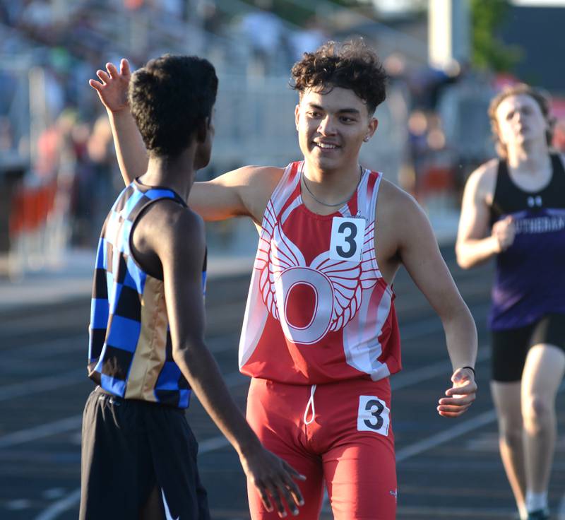 Oregon's Daniel Gonzalez (right) reaches out to embrace Rockford Christian's Andrew Kurien at the end of the 800 meters at the 1A Winnebago Sectional on Friday, May 17, 2024 in Winnebago.  Kurien won the race and Gonzalez too second.. Both advanced to the state finals at Eastern Illinois University in Charleston next week.