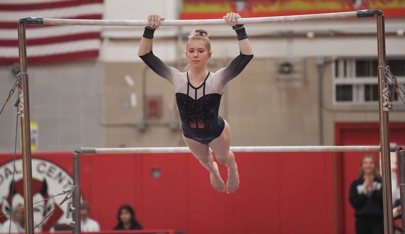 Oswego’s Sam Phillip on the uneven parallel bars at the Hinsdale Central girls gymnastics sectional meet in Hinsdale on Monday, Feb. 5, 2024.