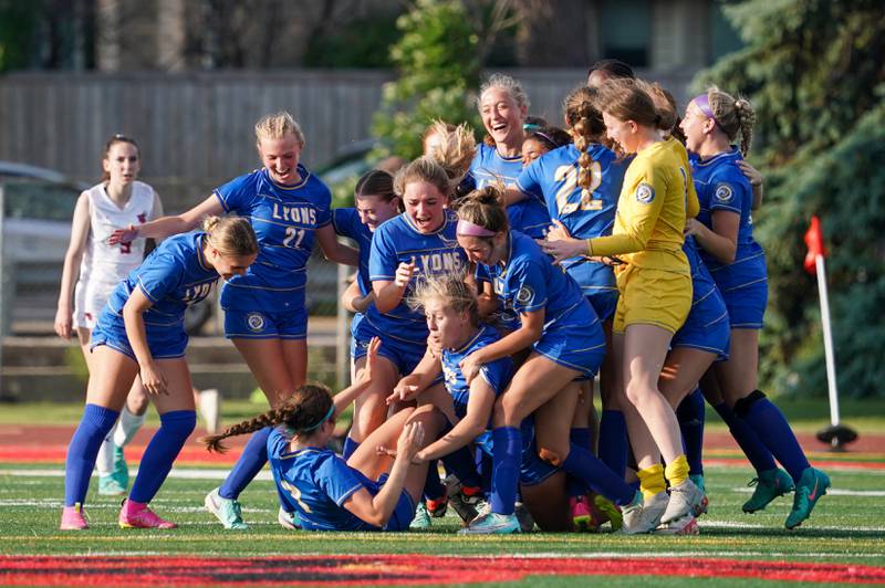 Lyons players celebrate after defeating Hinsdale Central in a Class 3A Hinsdale Central Sectional semifinal soccer match at Hinsdale Central High School in Hinsdale on Tuesday, May 21, 2024.