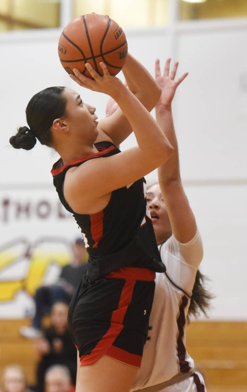 Benet Academy’s Emma Briggs, left, makes a move in the post against Montini’s Alyssa Epps during the semifinal of the Montini girls basketball tournament Thursday December 28, 2023 in Lombard.